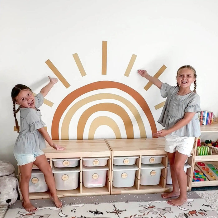 Rainbow wall decal with radiating lines in earth-tone colors.